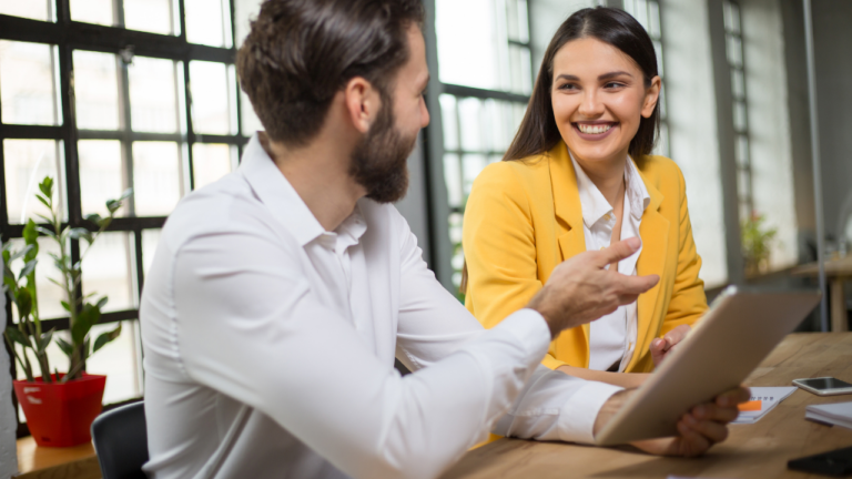 Michigan small business team reviewing employee insurance benefits options during open enrollment