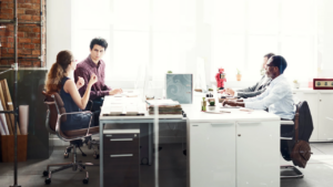 Open office with employees working at desks during Q4 workers' comp and benefits prep